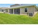 Expansive backyard view showcasing the screened-in patio and well-maintained lawn at 2803 130Th E Ave, Parrish, FL 34219