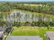 Aerial view of the property showcasing the expansive backyard, scenic pond, and lush green landscaping at 2803 130Th E Ave, Parrish, FL 34219