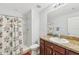 Bathroom features vanity with granite countertop and a shower with floral shower curtain at 2803 130Th E Ave, Parrish, FL 34219