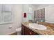 Bathroom features a vanity with granite countertop, mirror, and window for light at 2803 130Th E Ave, Parrish, FL 34219