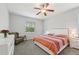 Inviting bedroom with large window, decorative quilt, bedside tables, dresser, chair, and soft carpet at 2803 130Th E Ave, Parrish, FL 34219