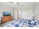Bedroom features double closets, dresser with a TV, and a comfortable bed at 2803 130Th E Ave, Parrish, FL 34219