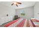 Inviting bedroom with dresser, reading chair, large window, ceiling fan, and plush carpet at 2803 130Th E Ave, Parrish, FL 34219
