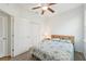 Bright bedroom featuring a bed with decorative quilt, ceiling fan, and closet with ample storage space at 2803 130Th E Ave, Parrish, FL 34219