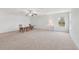 Spacious bonus room features neutral carpet, ceiling fan, and lots of natural light from the window at 2803 130Th E Ave, Parrish, FL 34219