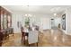 Bright dining area with large windows, elegant chandelier, and smooth transition to other spaces at 2803 130Th E Ave, Parrish, FL 34219