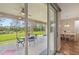 Covered and screened lanai adjacent to dining room with white chairs and table at 2803 130Th E Ave, Parrish, FL 34219