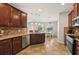 Open kitchen with granite countertops, stainless steel appliances, and dark wood cabinets at 2803 130Th E Ave, Parrish, FL 34219