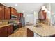 Modern kitchen with stainless steel appliances, granite countertops, and dark wood cabinetry at 2803 130Th E Ave, Parrish, FL 34219