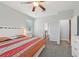 Sunlit main bedroom with an ensuite bathroom and closet, ceiling fan, and soft carpet floors at 2803 130Th E Ave, Parrish, FL 34219