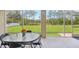 Screened patio features an oval glass table with seating and a view of the lake at 2803 130Th E Ave, Parrish, FL 34219