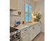 Kitchenette area with window shutters, butcher block counters, and white cabinets, offering charm and functionality at 2904 N Ola Ave, Tampa, FL 33602