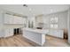 Modern kitchen with white cabinets, stainless steel appliances, large island, and hardwood floors at 2904 N Ola Ave, Tampa, FL 33602