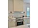 Gourmet kitchen features stainless steel appliances, designer hood, and sleek countertops at 2904 N Ola Ave, Tampa, FL 33602