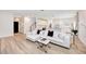 Open-concept living room with hardwood floors, white sectional sofa, and modern decor at 2904 N Ola Ave, Tampa, FL 33602