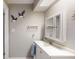 Bathroom featuring white vanity, framed mirror, and decorative accents at 3075 Rosery Ne Rd, Largo, FL 33771