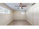 Empty bedroom featuring wood floors, a ceiling fan, and a double window at 3075 Rosery Ne Rd, Largo, FL 33771