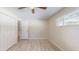 Bedroom with wood-look floors, a ceiling fan, and a large window at 3075 Rosery Ne Rd, Largo, FL 33771