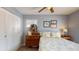 This bedroom has light blue walls, a ceiling fan, and a wood dresser at 3075 Rosery Ne Rd, Largo, FL 33771