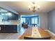 View of the kitchen and living room from the dining room with wood floors at 3075 Rosery Ne Rd, Largo, FL 33771