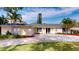 Charming single-story home featuring a well-manicured lawn, ample parking, and inviting curb appeal at 3075 Rosery Ne Rd, Largo, FL 33771