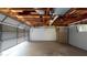 Empty garage with an exposed wood ceiling and concrete floors at 3075 Rosery Ne Rd, Largo, FL 33771