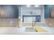Kitchen with a sink, countertop, and a window looking into the living area at 3075 Rosery Ne Rd, Largo, FL 33771