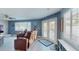 Living room with view to the exterior pool area through glass doors at 3075 Rosery Ne Rd, Largo, FL 33771