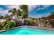 Refreshing pool area surrounded by lush landscaping and a patio set for outdoor relaxation at 3075 Rosery Ne Rd, Largo, FL 33771