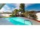 Inviting pool area set amongst mature palm trees, offering an outdoor space to relax at 3075 Rosery Ne Rd, Largo, FL 33771