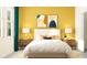Stylish main bedroom with modern décor, featuring nightstands, lamps, and colorful artwork above the headboard at 31744 Parkland Bay Way, San Antonio, FL 33576