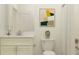 Neutral bathroom with a granite countertop, white cabinetry, framed art, and shower with bright lighting at 31793 Griffin Sands Ln, San Antonio, FL 33576