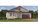 Charming one-story home with a brick driveway, neutral siding, well-manicured lawn and a two-car garage at 31793 Griffin Sands Ln, San Antonio, FL 33576