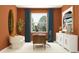 Bright home office features modern desk, chairs and storage with large art piece for inspiring workspace at 31793 Griffin Sands Ln, San Antonio, FL 33576