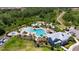 Aerial view of the pool, and a playground and clubhouse at 32628 Harmony Oaks Dr, Wesley Chapel, FL 33545