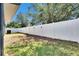 Backyard featuring a white vinyl fence providing privacy at 32628 Harmony Oaks Dr, Wesley Chapel, FL 33545