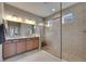 Modern bathroom featuring a glass-enclosed shower, granite countertop, and neutral tile flooring at 32628 Harmony Oaks Dr, Wesley Chapel, FL 33545
