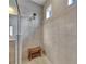 Contemporary walk-in shower with tiled walls, rainfall shower head and built-in bench at 32628 Harmony Oaks Dr, Wesley Chapel, FL 33545