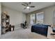 Bedroom with carpet and ceiling fan with shelves and desk at 32628 Harmony Oaks Dr, Wesley Chapel, FL 33545