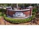 Welcome to Cypress Village community sign surrounded by lush landscaping at 32628 Harmony Oaks Dr, Wesley Chapel, FL 33545