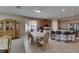Dining area with wood cabinets, stone countertops, island with seating, and tile floors at 32628 Harmony Oaks Dr, Wesley Chapel, FL 33545