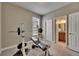Neutral exercise room with a weight bench and bathroom located through door at 32628 Harmony Oaks Dr, Wesley Chapel, FL 33545