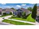 Beautiful single-Gathering home with a manicured lawn, mature trees, and a two-car garage at 32628 Harmony Oaks Dr, Wesley Chapel, FL 33545