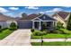 Charming single-story home featuring a well-manicured lawn and inviting curb appeal at 32628 Harmony Oaks Dr, Wesley Chapel, FL 33545