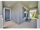 Inviting front porch with a blue door, shutters, and a cozy seating area at 32628 Harmony Oaks Dr, Wesley Chapel, FL 33545