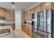 Modern kitchen features stainless steel appliances, granite countertops, and ample cabinet space at 32628 Harmony Oaks Dr, Wesley Chapel, FL 33545