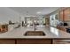 Kitchen island featuring a stainless steel sink with granite countertops at 32628 Harmony Oaks Dr, Wesley Chapel, FL 33545