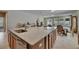 Kitchen island featuring granite countertops, stainless steel sink, and ample cabinet space at 32628 Harmony Oaks Dr, Wesley Chapel, FL 33545