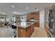 Open kitchen and dining area with island seating and stainless steel appliances at 32628 Harmony Oaks Dr, Wesley Chapel, FL 33545