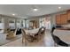 Spacious open floor plan with a dining table, living room, and windows at 32628 Harmony Oaks Dr, Wesley Chapel, FL 33545
